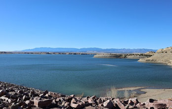 Pueblo Reservoir in the distance showing blue waters and blue sky Photo courtesy of Wikimedia Commons